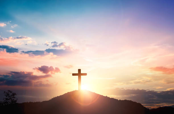 istock Silhouette wooden cross on mountain sunset background 1818686576