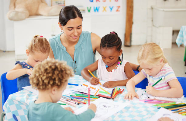 istock Help, teacher and woman with education, students and ideas with conversation, lessons and teaching. Person, educator and children writing, knowledge and kids in a classroom with answers and learning 1818697704