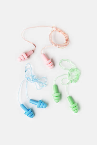 istock Creative flat lay from colored silicone earplugs for swim, sleep, rest on white background. Comfort ear plug on string against noise, protect hear, aesthetic top view, visual trends 1818698382