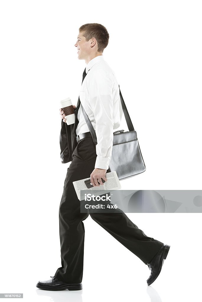 Side view of a businessman walking Side view of a businessman walkinghttp://www.twodozendesign.info/i/1.png Carrying Stock Photo