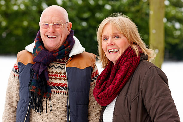 istock Happy senior couple in snow park 181870593