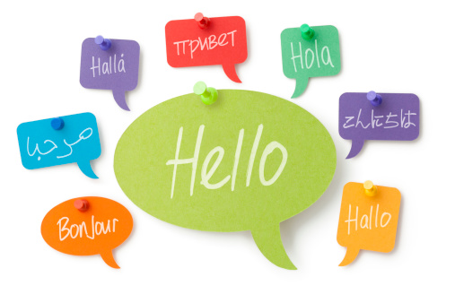 Hello handwritten in eight different languages on colourful card speech bubbles pinned to a white surface. Isolated on a pure white background, no dot in the white area so no need to cut-out e.g. can be dropped directly on to a white web page seemlessly.