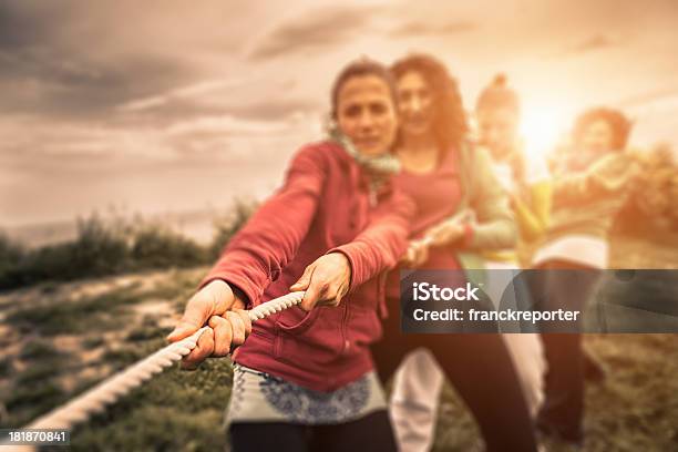 Group Of People Engaging In Tug Of War Stock Photo - Download Image Now - Tug-of-war, Rope, Sports Team