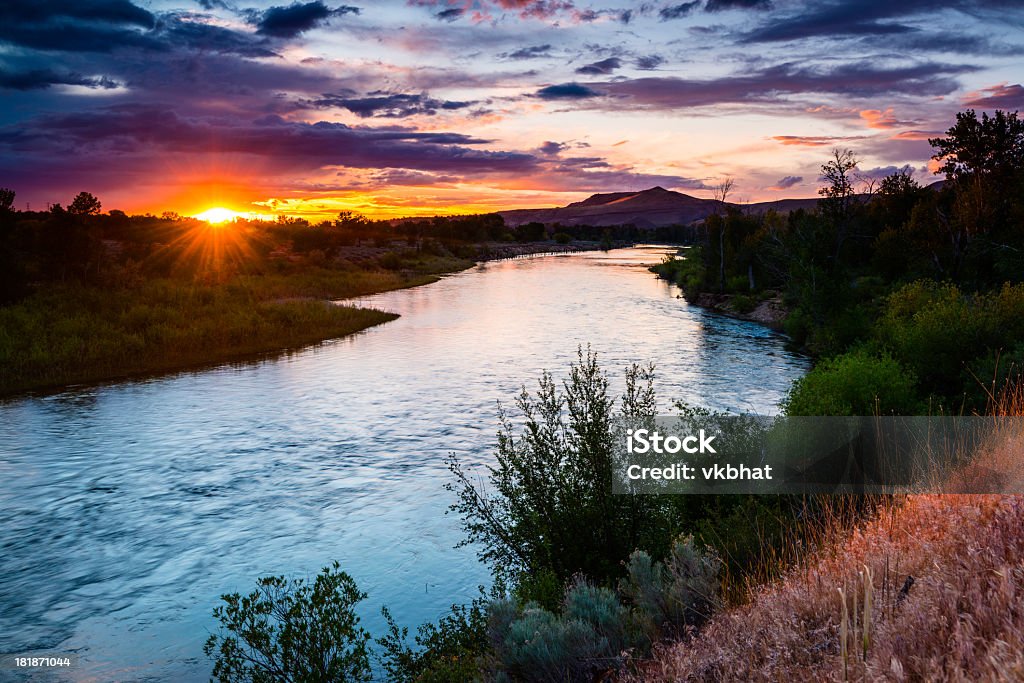 Boise river meandering through a lush landscape at sunset "Beautiful and colorful sunset over Boise river,Boise Idaho,USA Please visit my below Lightboxes for more Boise and Idaho Image options:" Idaho Stock Photo