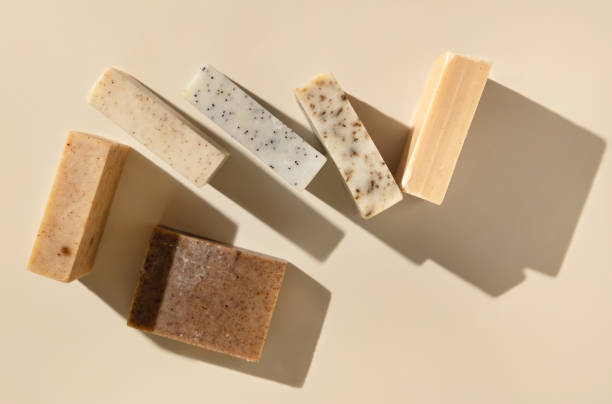 istock Natural herbal beige and brown soap bars on light beige top view, hard shadows 1818711648