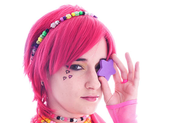 Bright summer portrait of a positive, gorgeous girl with pink hair posing on studio colorful background