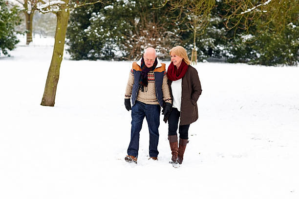 istock Senior couple walking together in snow 181871785