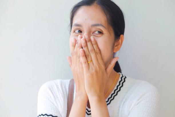 istock Surprised Thai woman  covering mouth with hands 1818721265