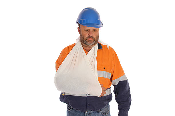 Sad Injury A sad worker with injured arm. man with arm sling stock pictures, royalty-free photos & images