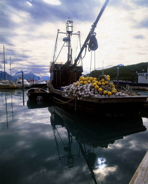 A large bundle of orange  buoys chained on a high deck north of Gig Harbor Marina