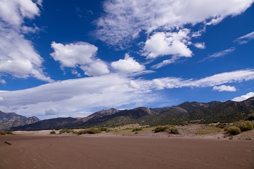 The Great Sand Dunes captures the beauty of mountains and deep blue skies and the sifting sands from the San Luis Valleys wind patterns. Some sand dunes are as tall as 750 ft and in the spring the snow melt forms the Medano creek area.