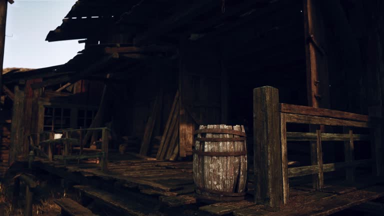 A rustic wooden barrel next to a weathered wooden fence