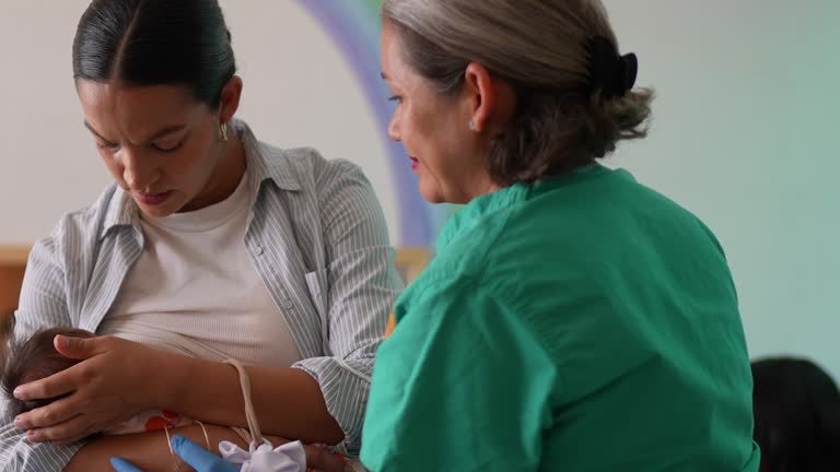 Mature woman learning to breastfeed her daughter in support group