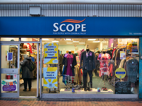 The frontage of a Scope charity shop. Scope is a UK charity that campaigns to change negative attitudes about disability, provides direct services, and educates the public.