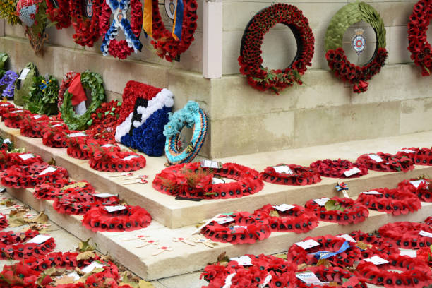 Whitehall, London, United Kingdom, November 16, 2023. Cenotaph War Memorial surrounded by red poppies and wreaths laid in tribute on Remembrance Sunday. Overcast Autumn day outdoors