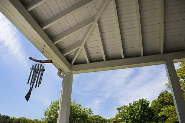 The gentle sound of windchimes fill an open covered porch with every springtime breeze on Cape Cod.