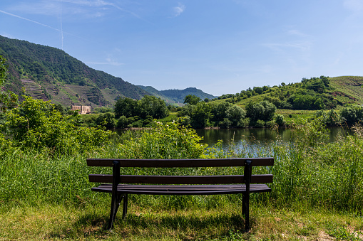 Bremm, Rhineland-Palatine, Germany - June 15, 2021: A bench with a view over the Moselle Valley and the Stuben Abbey ruin