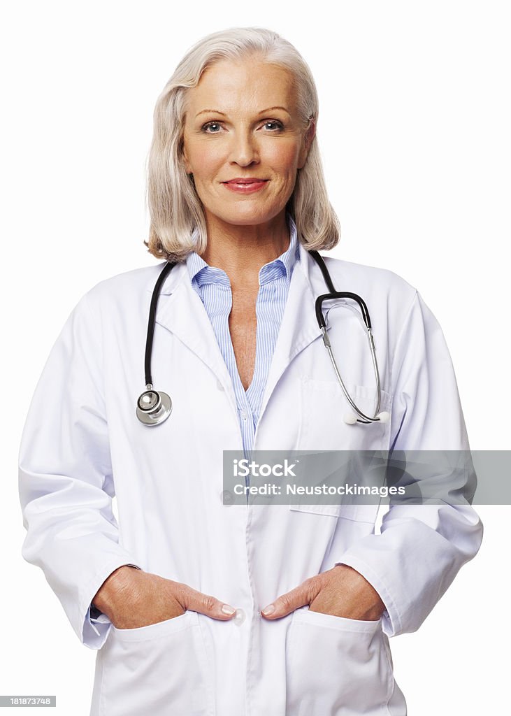 Confident Female Doctor - Isolated Portrait of confident senior female doctor smiling with hands in pockets. Vertical shot. Isolated on white. 60-69 Years Stock Photo