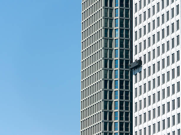istock Window cleaning black basket on white building 181873822