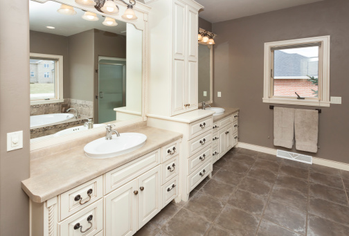 Spacious Bathroom With Custom Cabinetry and Tile Floor