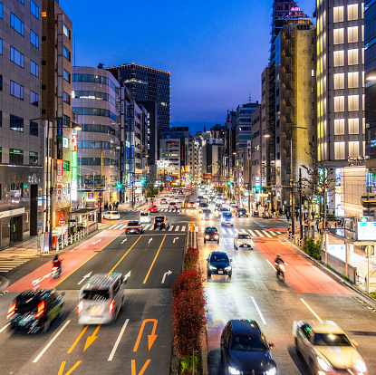 Motion blur as busy evening traffic passes on a major street in Akihabara in the Chiyoda district of Tokyo, Japan.