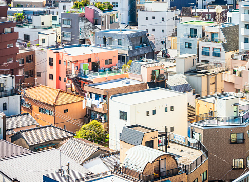 A view from above a large number of houses and apartment buildings in the Chiyoda ward of Tokyo, Japan.