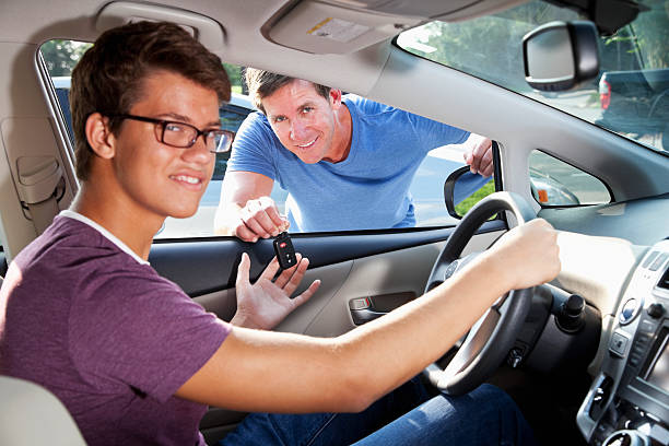 istock Father handing son car keys 181874644