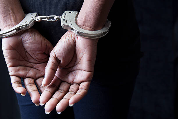 Arrested Black woman in handcuffs cuff stock pictures, royalty-free photos & images