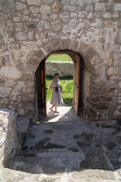 istock Woman standing in a window 1818748198
