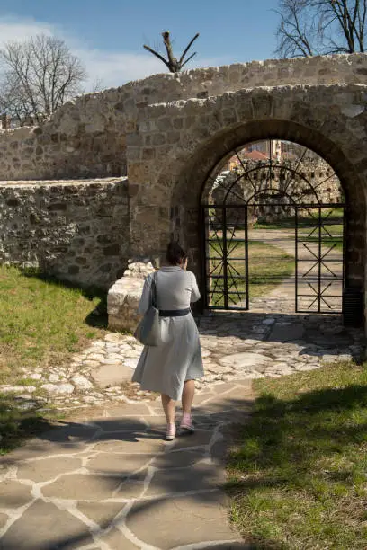 Photo of woman backpacker is walking in the ancient ruins