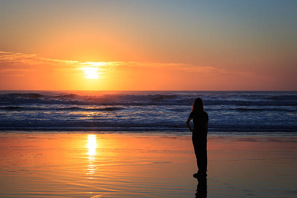 istock Woman Silhouette on a Tropical Beach at Sunrise 181874862