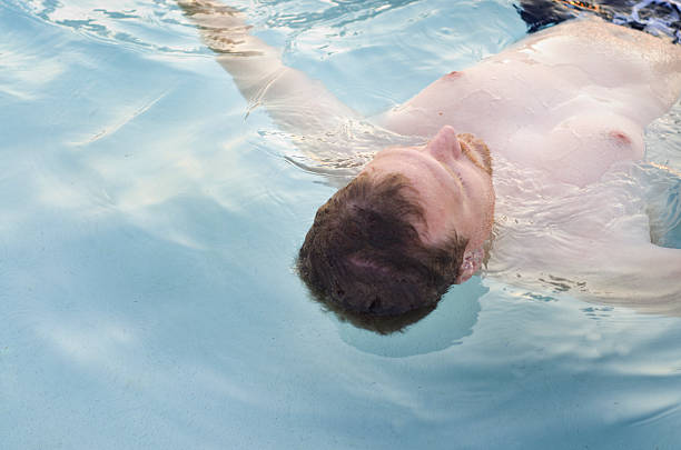 istock man floats on the water relaxing in a pool 181874909