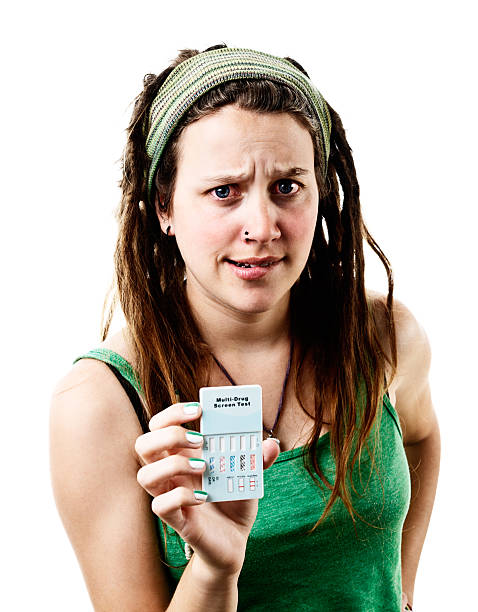 istock Busted! Young rebel grimaces, holding up home multi-drug test kit 181875014