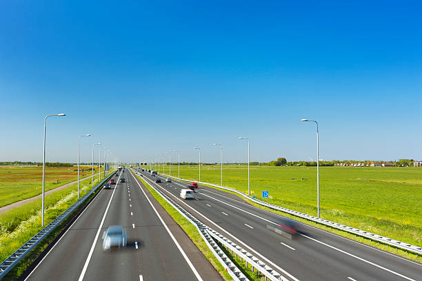 istock Highway through grassy fields on a sunny day, The Netherlands 181875087