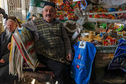 Istaravshan, Tajikistan - November 26, 2023: Portrait of a seller at the Istaravshan Central Market, Tajikistan.