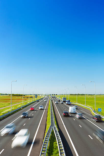 istock Highway through grassy fields on a sunny day, The Netherlands 181875221