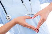 A female doctor making a heart with her hands