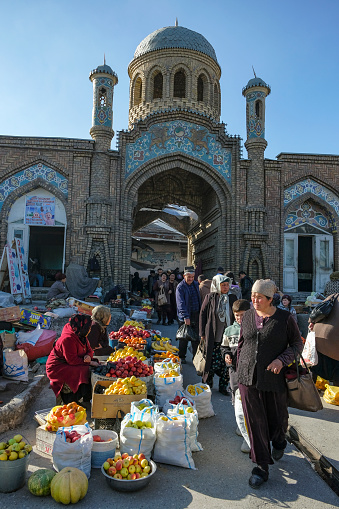 Istaravshan, Tajikistan - November 26, 2023: Fruit sellers at the gate of the Istaravshan Central Market, Tajikistan.