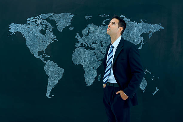 istock Thoughtful businessman by world map 181875520