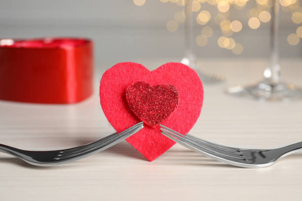 istock Forks and decorative heart on white table. Romantic place setting 1818756670