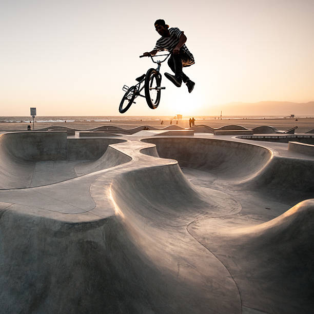 BMX Biker A BMX biker at the bike park at sunset. venice beach bike stock pictures, royalty-free photos & images