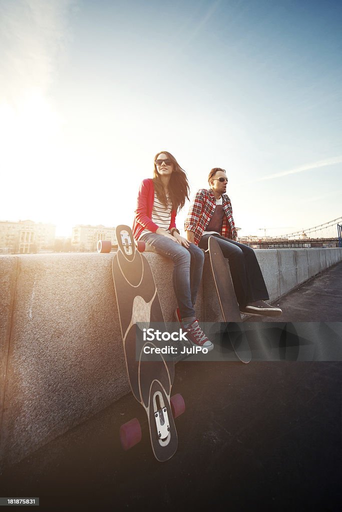 Longboarding Young couple with longboards in park Activity Stock Photo