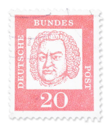 Vintage German stamp with Johann Sebastian Bach portrait. Isolated on white with light shadow. Canon 5D Mark II.