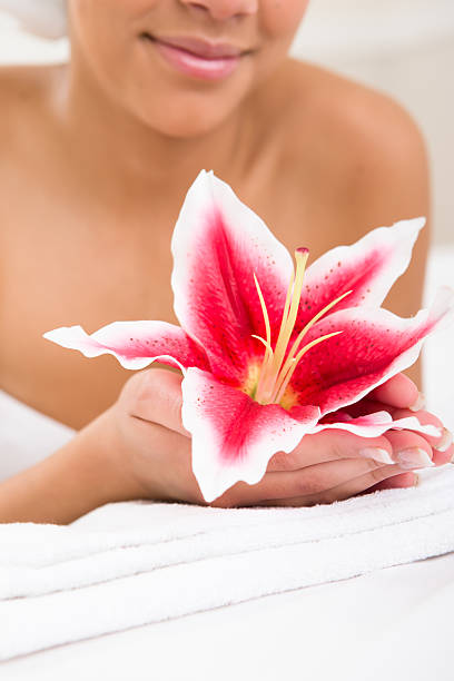 Woman holding stargazer in palm