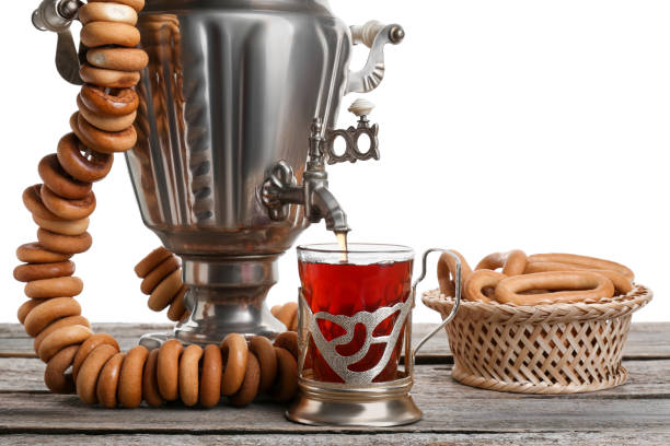 istock Samovar with hot tea, jam and delicious ring shaped Sushki (dry bagels) on table against white background 1818764863