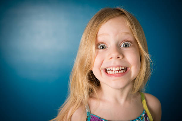 istock Five Year Old Girl Making Funny Face at Camera 181876646