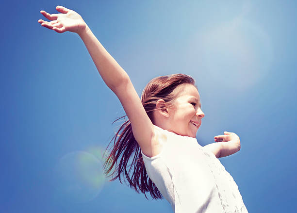 istock Little girl with arms raised 181876653