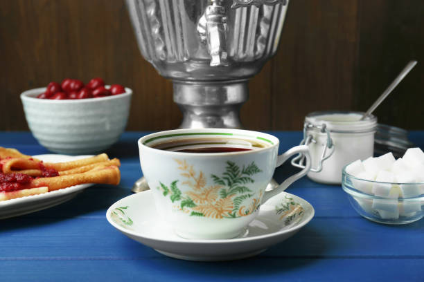 istock Aromatic tea, traditional Russian samovar and treats on light blue wooden table 1818767057
