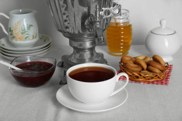 istock Composition with delicious ring shaped Sushki (dry bagels) and tea on white tablecloth near wall 1818768684