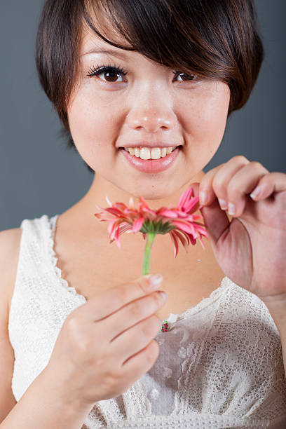 istock pregnant woman holding rose 181876882